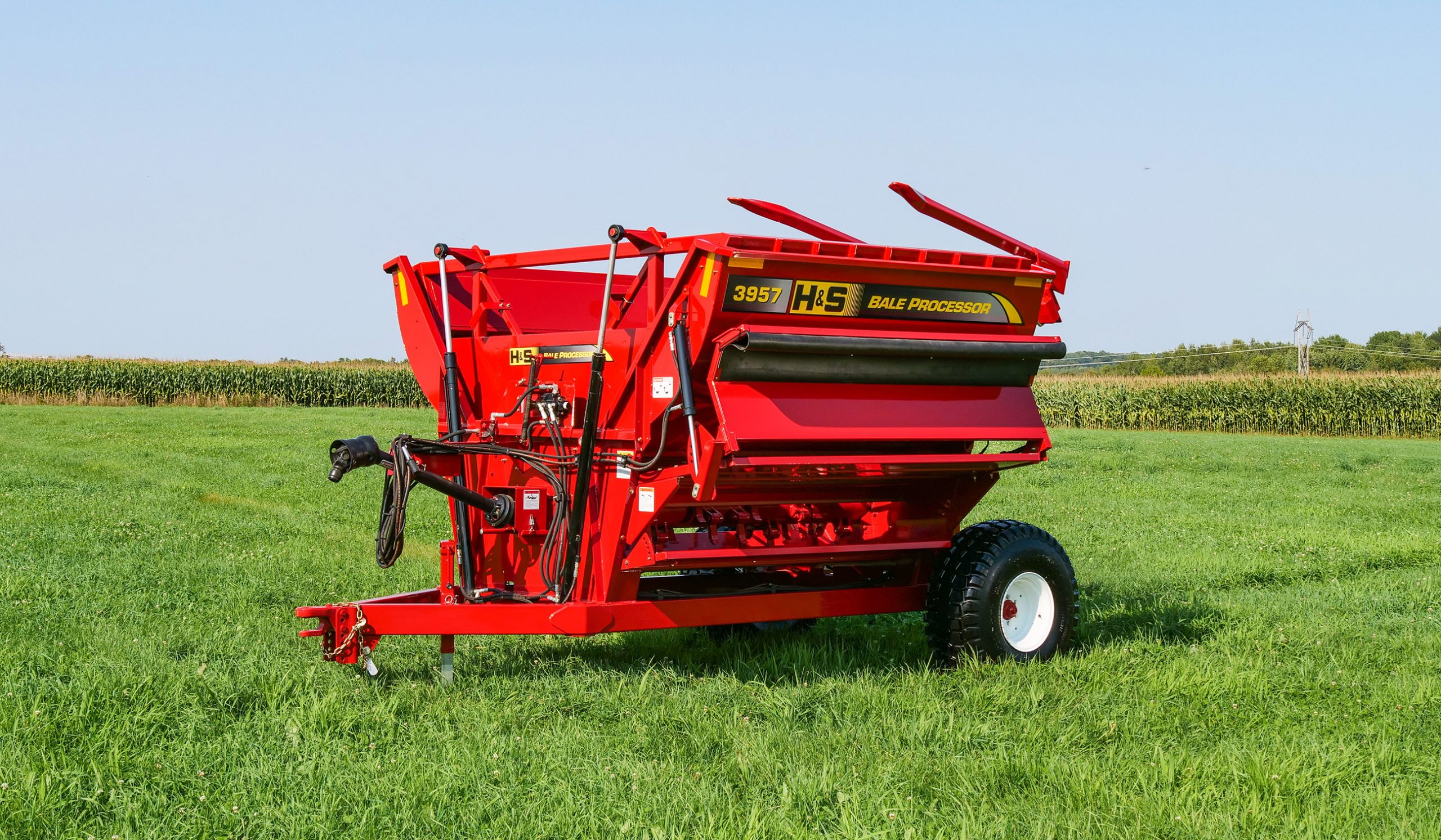 H&S 3957 left hand discharge bale processor in a field