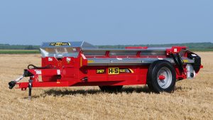 H&S 3127 heavy duty manure spreader in a field with jack down