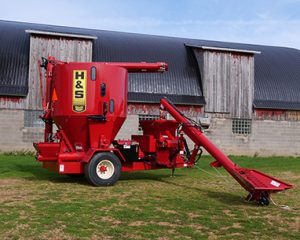 H&S 7117 roller mixer in front of barn