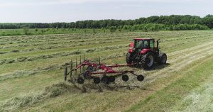 H&S 2210 10-wheel action rake raking hay in a field