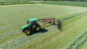 H&S 2212 12-wheel action rake raking hay in the field