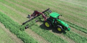H&S 6136 ultra-flex merger merging alfalfa in a hay field